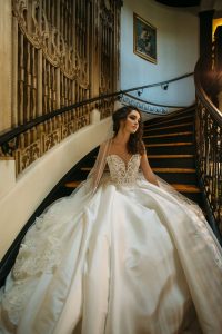 Bride descending mansion staircase